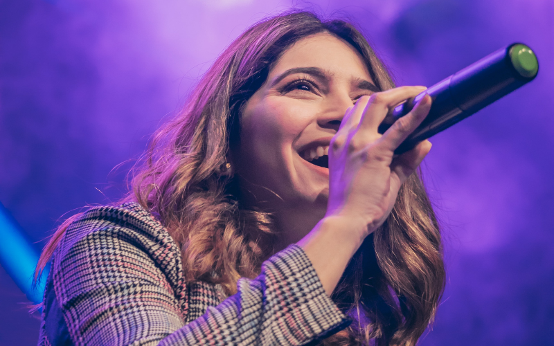 lady singing on stage with mic